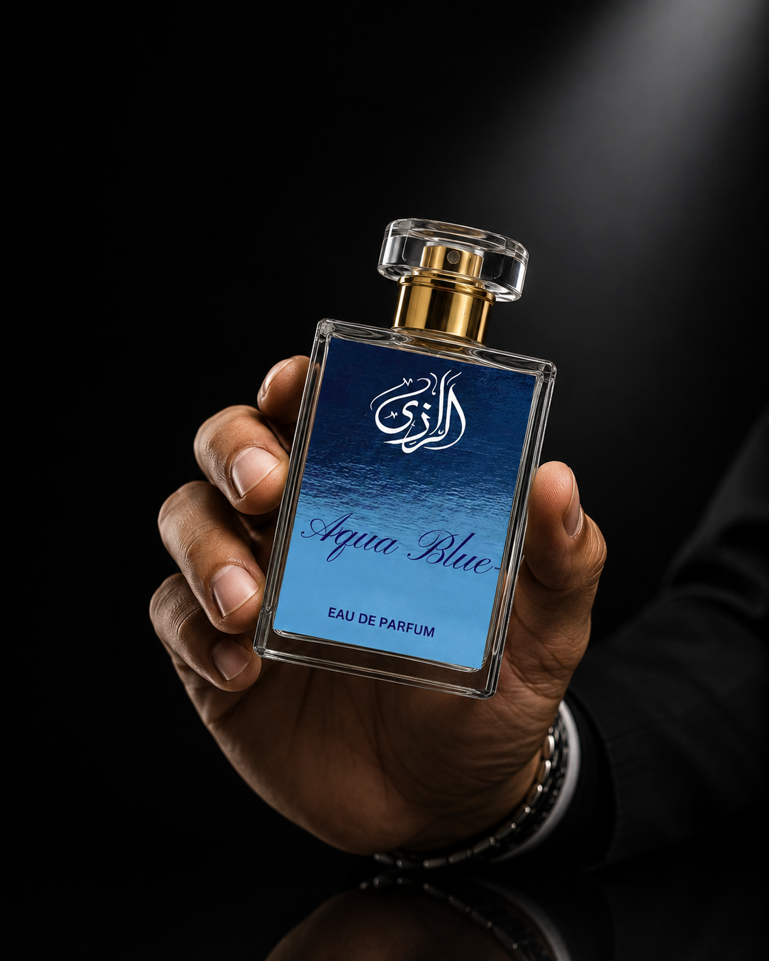 Aqua Blue perfume by Al-Razi for men – luxury fragrance bottle held in a man's hand against a dark studio background